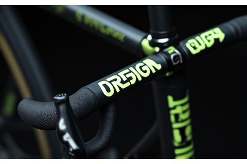 Road bike with reflective custom text stickers on top tube and handlebars